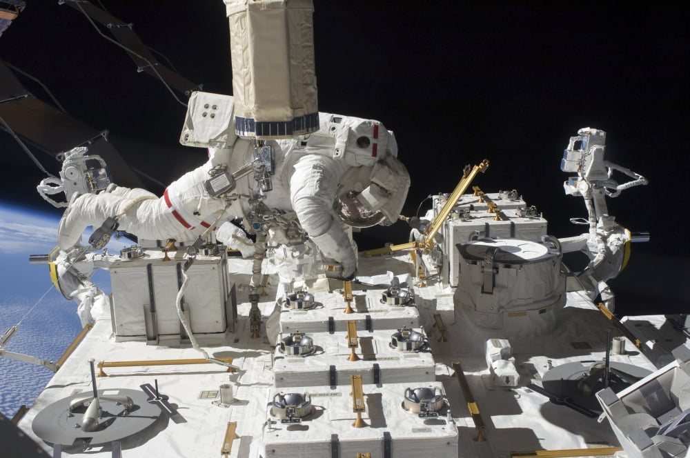 Astronaut working on the International Space Station during a spacewalk Canvas Art - Stocktrek Images (34 x 23)
