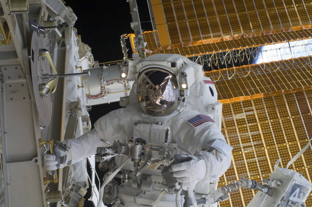 Astronaut working on the International Space Station during a spacewalk Canvas Art - Stocktrek Images (35 x 23)