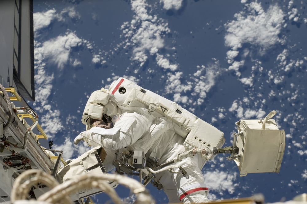 Astronaut working on the International Space Station during a spacewalk Canvas Art - Stocktrek Images (35 x 23)