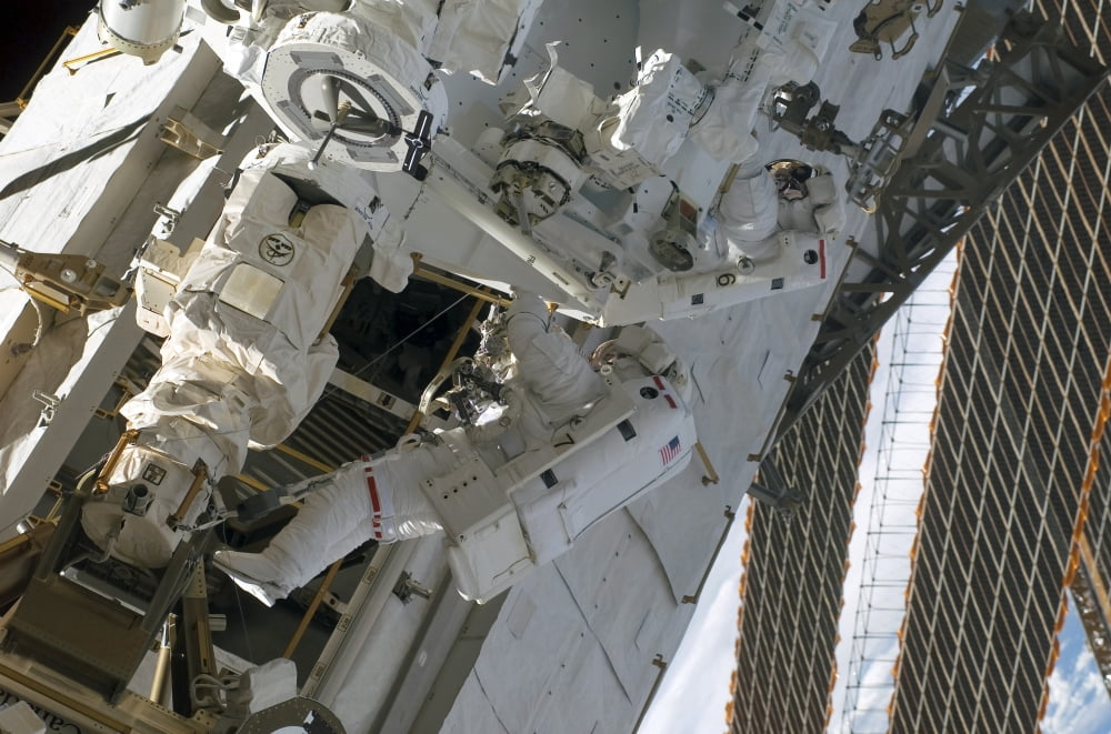 Astronauts assemble the stick-figure-shaped Dextre Canvas Art - Stocktrek Images (34 x 23)