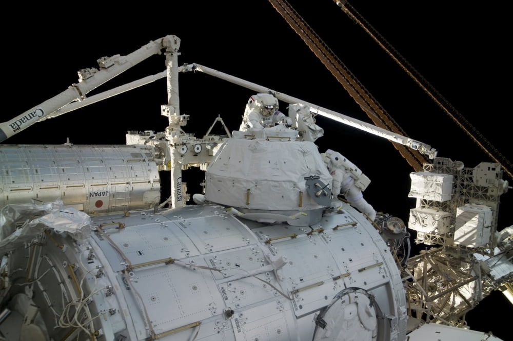 Astronauts participate in a session of extravehicular activity Canvas Art - Stocktrek Images (34 x 23)