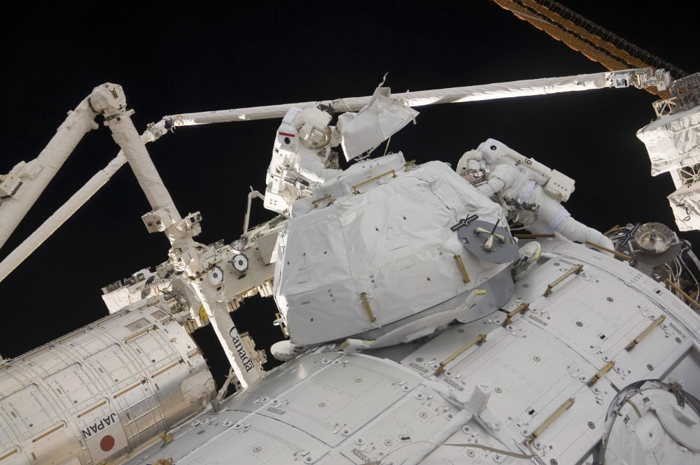 Astronauts participate in a session of extravehicular activity Canvas Art - Stocktrek Images (34 x 23)