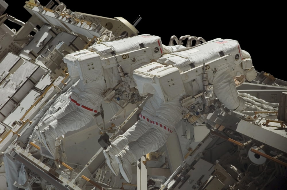 Astronauts participate in a spacewalk Canvas Art - Stocktrek Images (34 x 23)