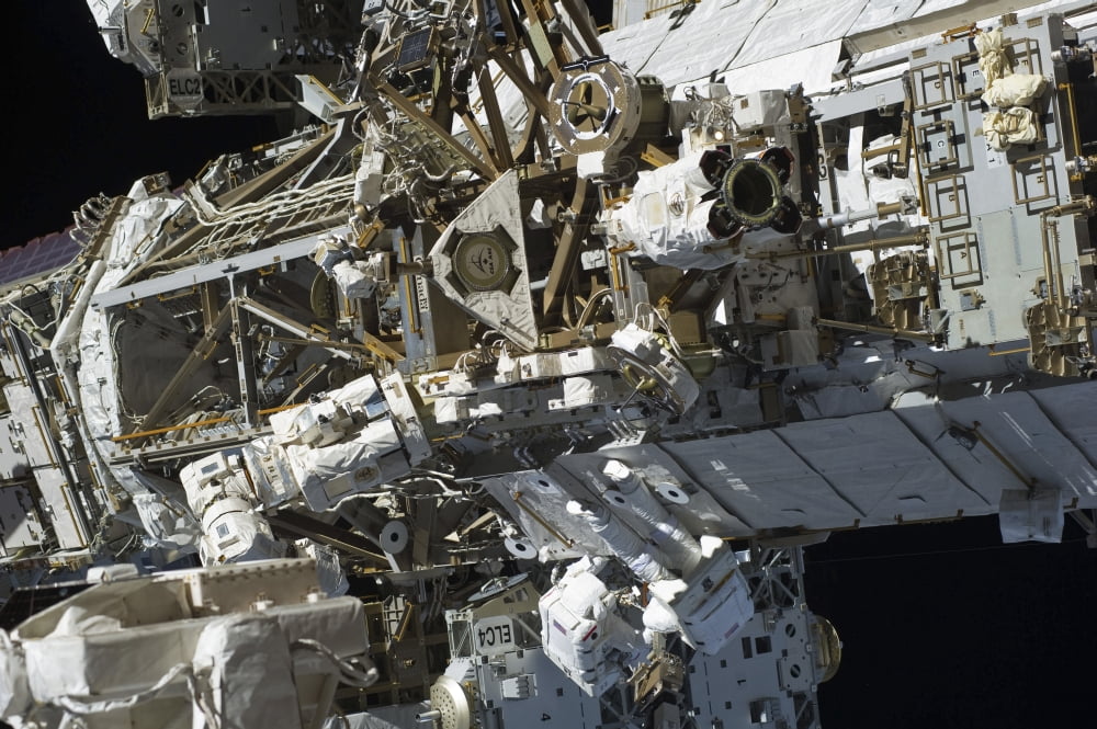 Astronauts participate in extravehicular activity Canvas Art - Stocktrek Images (35 x 23)