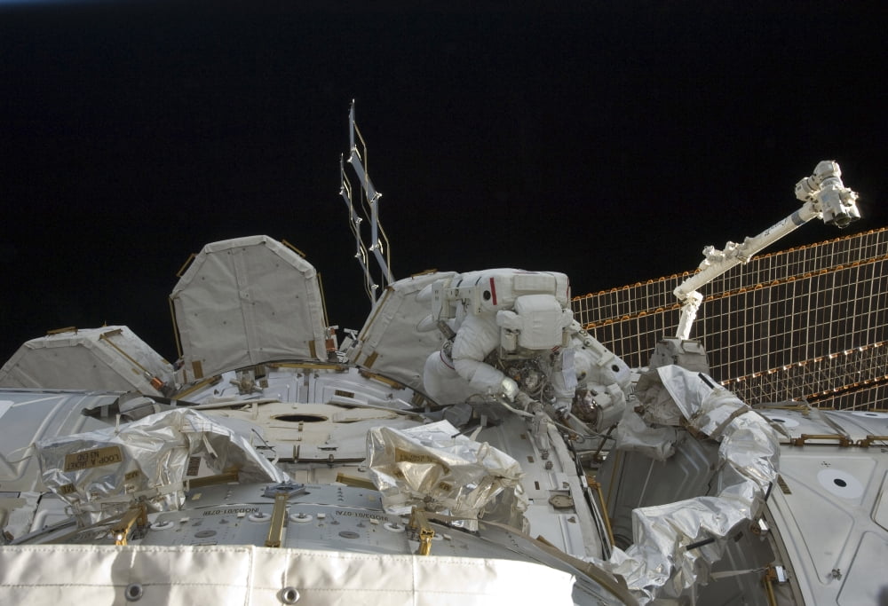 Astronauts participate in extravehicular activity on the International Space Station Canvas Art - Stocktrek Images (34 x 24)