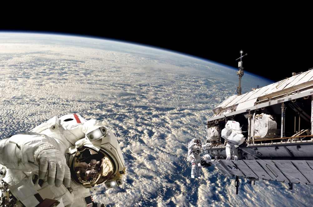 Astronauts performing work on a space station while orbiting Earth Canvas Art - Marc WardStocktrek Images (18 x 12)