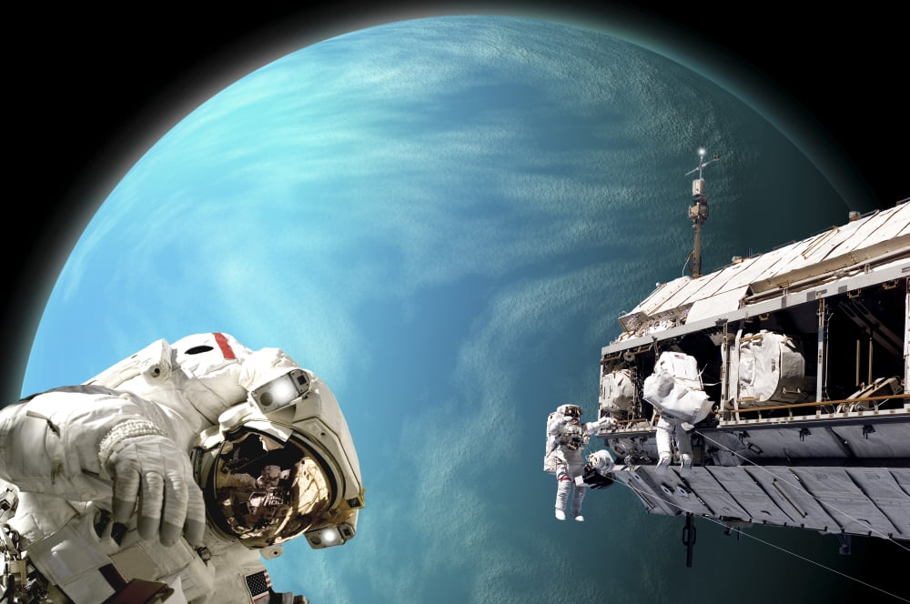 Astronauts performing work on a space station while orbiting a water covered planet Canvas Art - Marc WardStocktrek Images (18 x 12)