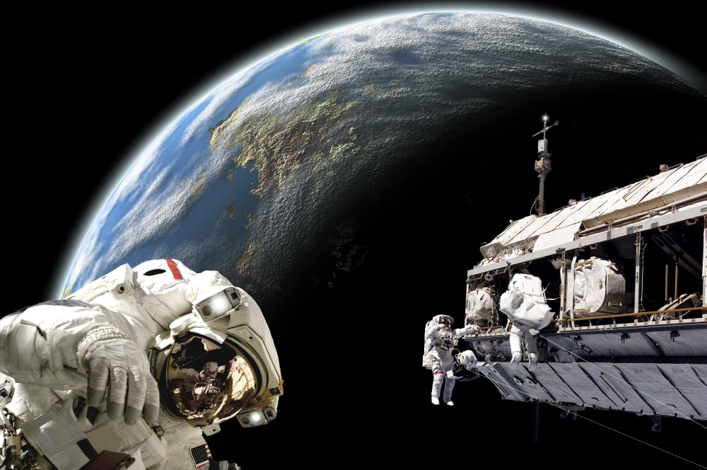 Astronauts performing work on a space station while orbiting an Earth-like planet Canvas Art - Marc WardStocktrek Images (18 x 12)