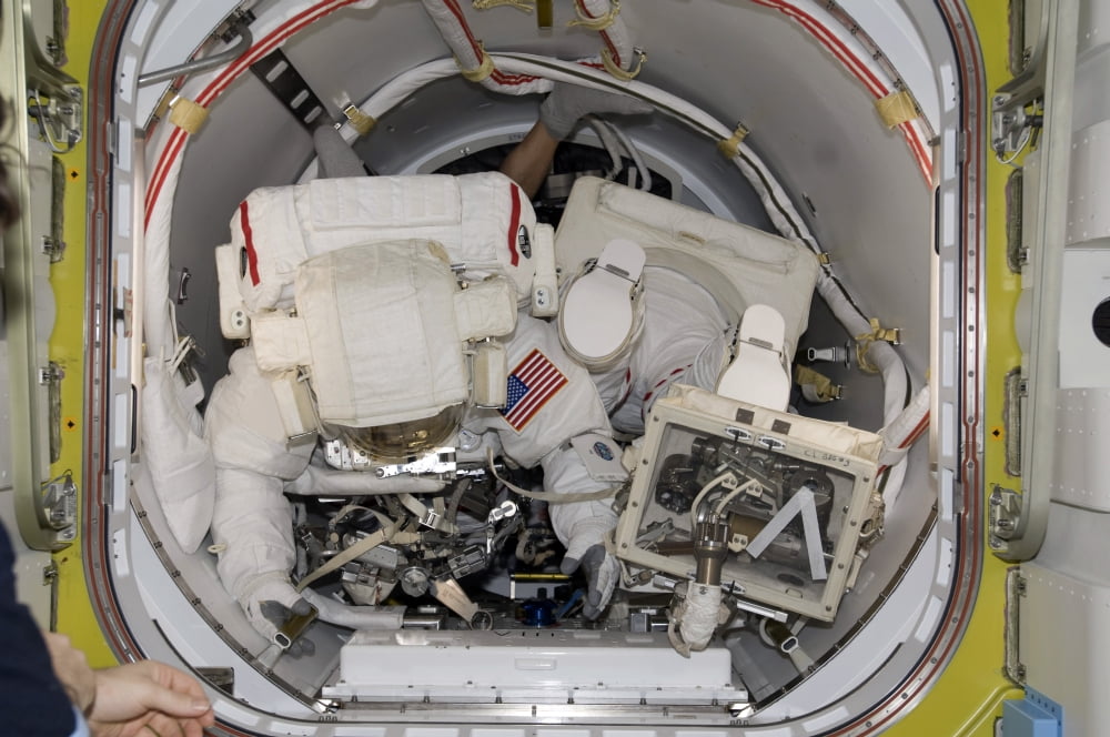 Astronauts preparing for extravehicular activity Canvas Art - Stocktrek Images (34 x 23)