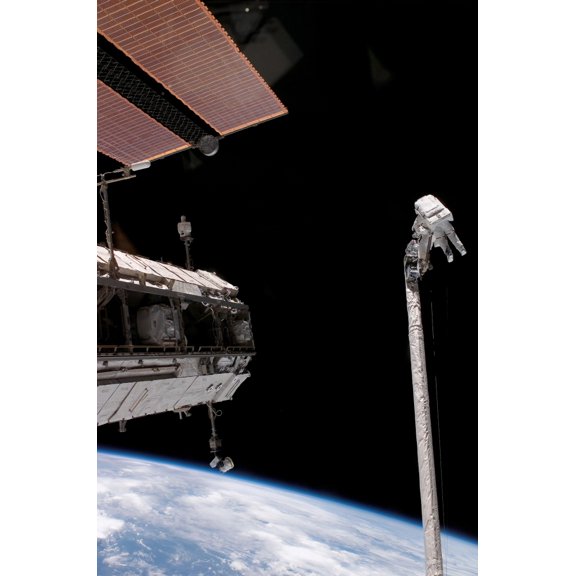 Astronauts work in tandem on the shuttles Remote Manipulator SystemOrbiter Boom Sensor System Canvas Art - Stocktrek Images (23 x 34)