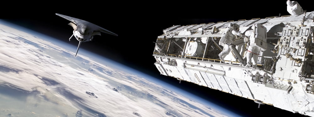 Astronauts work on a space station while a space shuttle approaches Canvas Art - Marc WardStocktrek Images (46 x 18)