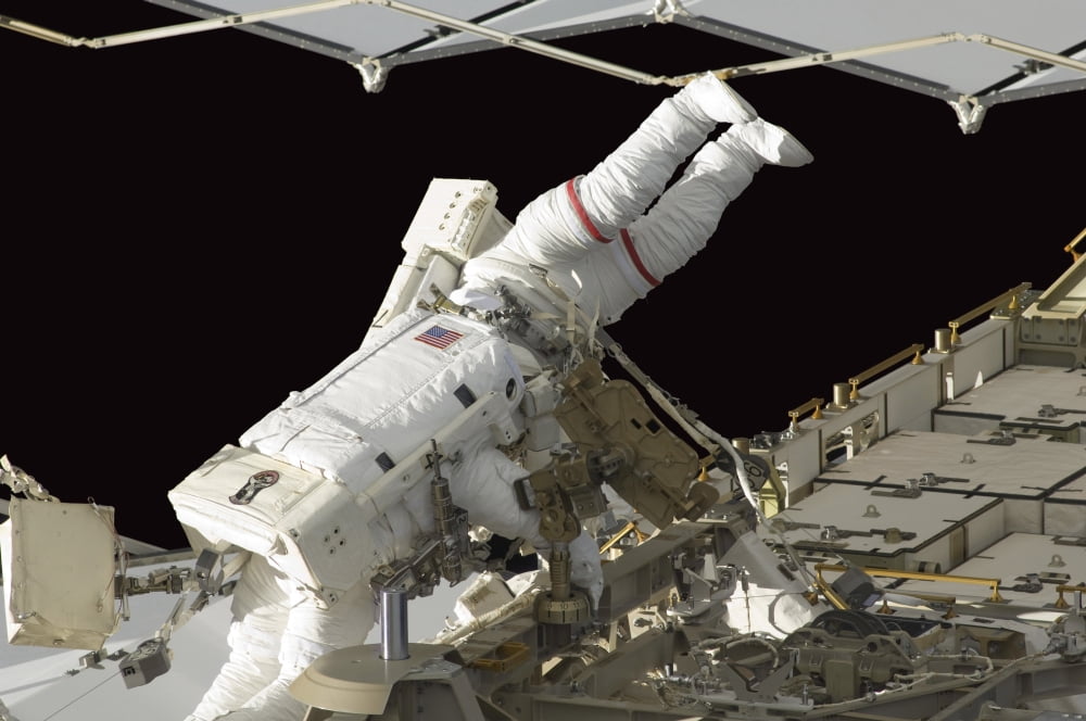 Astronauts work on the International Space Station during a spacewalk Canvas Art - Stocktrek Images (34 x 23)