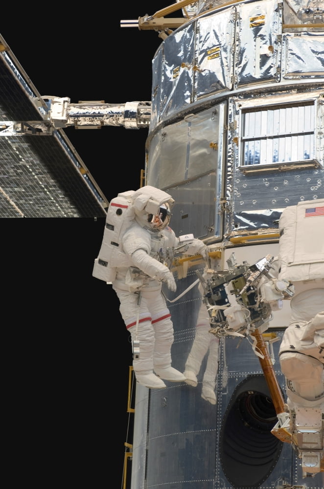 Astronauts working on the Hubble Space Telescope during a spacewalk Canvas Art - Stocktrek Images (23 x 34)