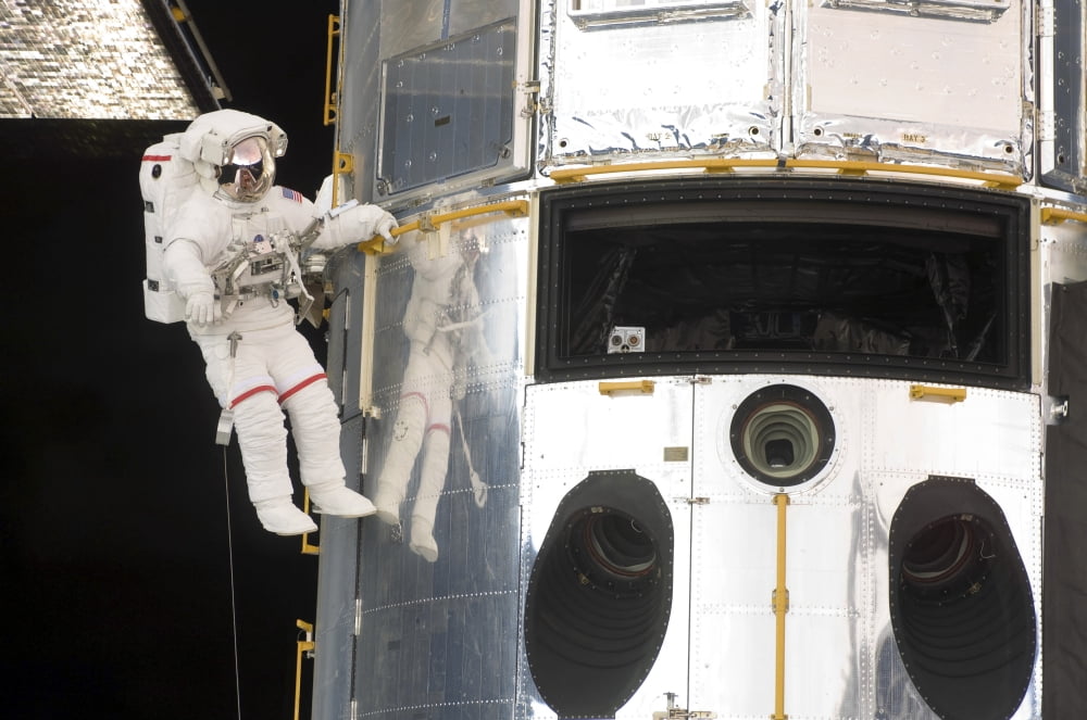 Astronauts working on the Hubble Space Telescope during a spacewalk Canvas Art - Stocktrek Images (34 x 23)