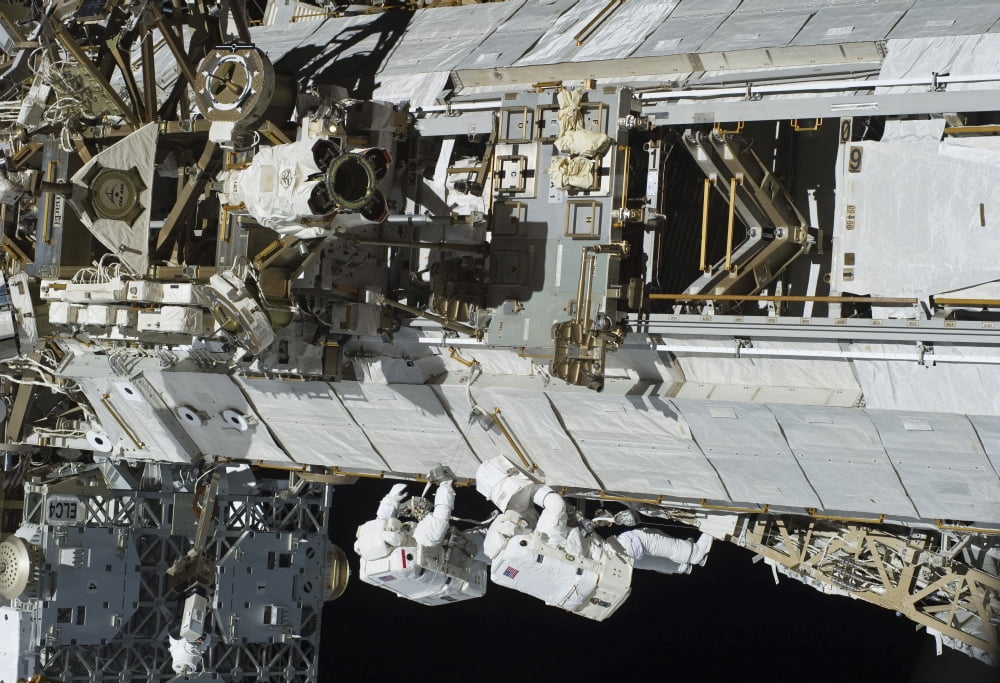 Astronauts working on the International Space Station Canvas Art - Stocktrek Images (34 x 24)