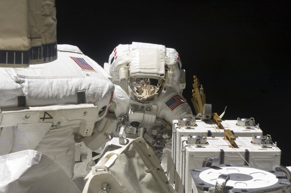 Astronauts working on the International Space Station during a spacewalk Canvas Art - Stocktrek Images (34 x 23)