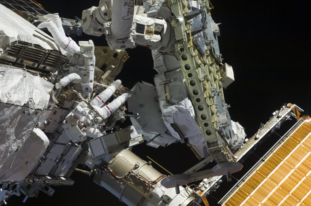 Astronauts working on the International Space Station during a spacewalk Canvas Art - Stocktrek Images (34 x 23)