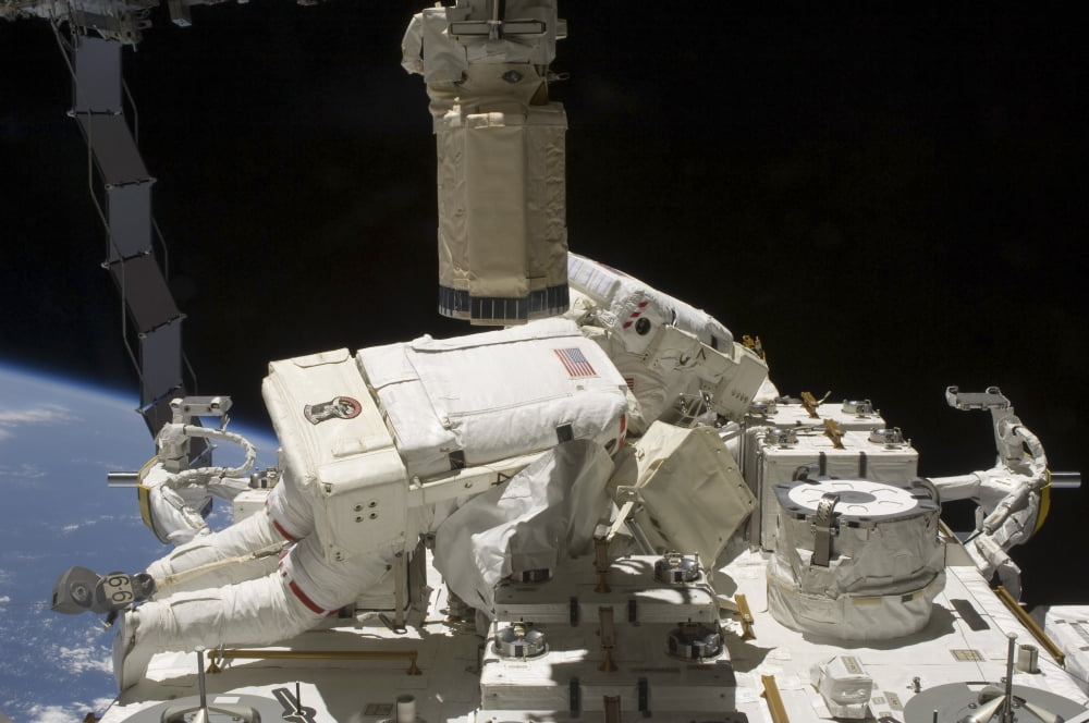 Astronauts working on the International Space Station during a spacewalk Canvas Art - Stocktrek Images (34 x 23)