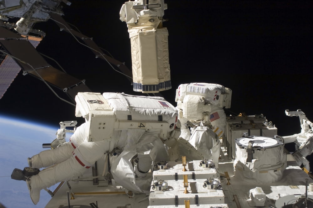 Astronauts working on the International Space Station during a spacewalk Canvas Art - Stocktrek Images (34 x 23)