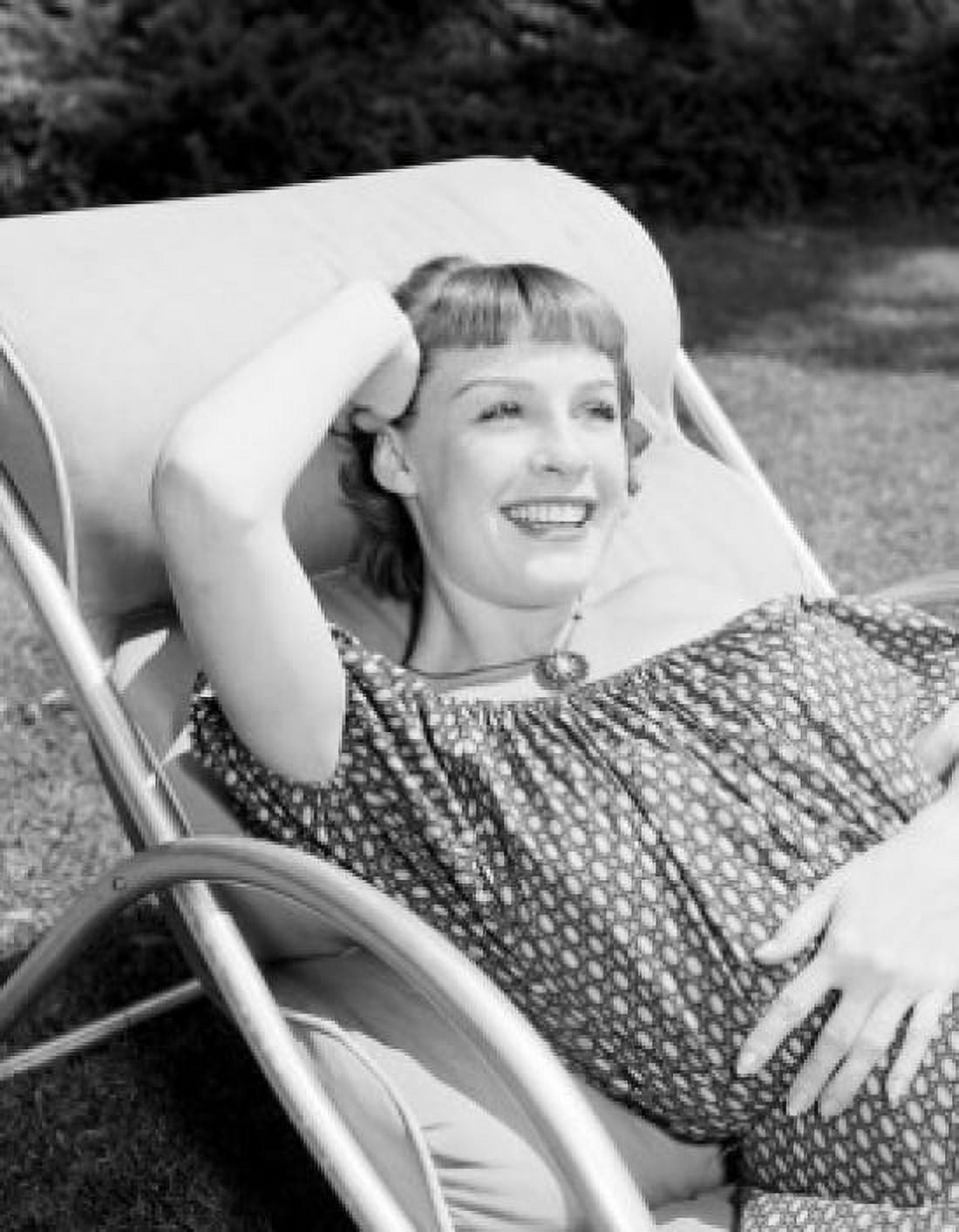 Attractive young woman resting on sun lounger Canvas Art - (24 x 36)