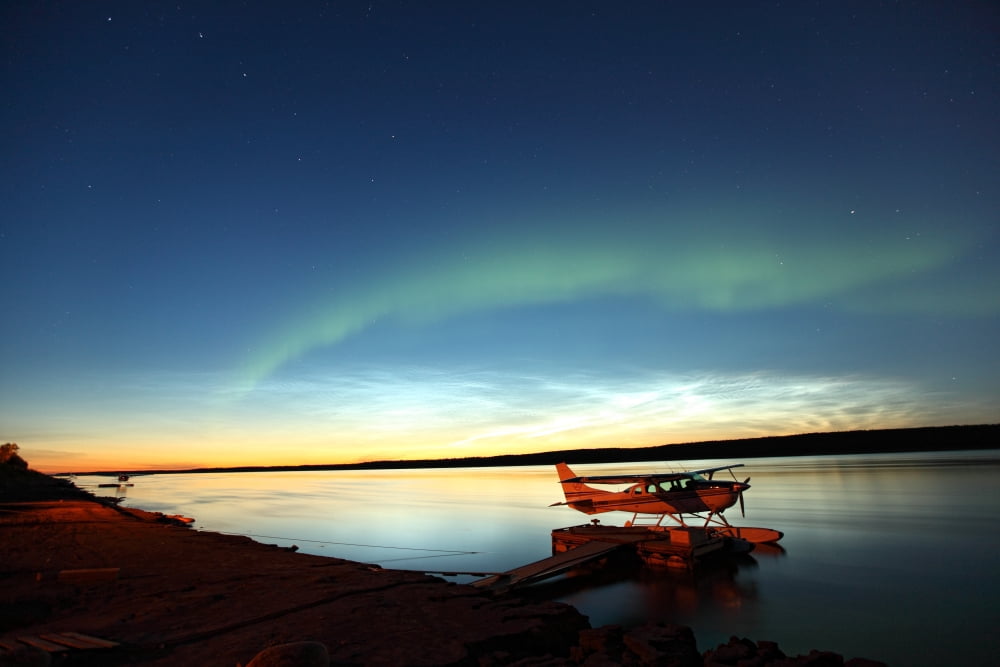 Aurora Borealis Over The Mackenzie River With Float Planes In Foreground Fort Simpson Northwest Territories Canvas Art - Robert Postma Design Pics (17 x 11)