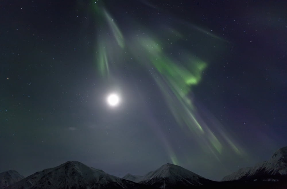 Aurora Borealis Or Northern Lights Above The Mountains Near Whitehorse Yukon Canvas Art - Robert Postma Design Pics (17 x 11)