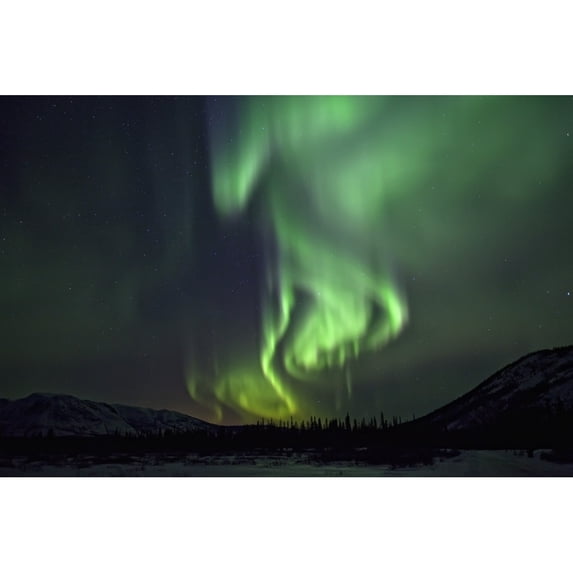 Aurora Borealis Or Northern Lights Above The Mountains Near Whitehorse Yukon. Poster Print (17 x 11)