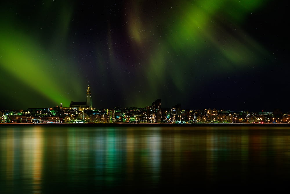 Aurora Borealis or Northern Lights over Reykjavik Skyline Reykjavik Iceland Canvas Art - Panoramic Images (36 x 12)