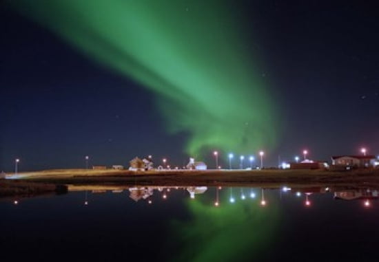 Aurora Borealis over a town Njardvik Iceland Canvas Art - Panoramic Images (36 x 25)