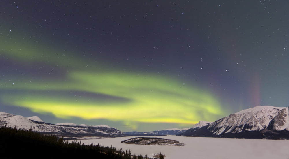 Aurora borealis over Bove Island Yukon Canada Canvas Art - Joseph BradleyStocktrek Images (19 x 11)