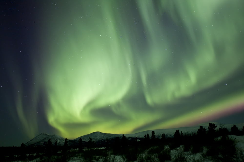 Aurora borealis over mountain Yukon Canada Canvas Art - Jonathan TuckerStocktrek Images (18 x 12)