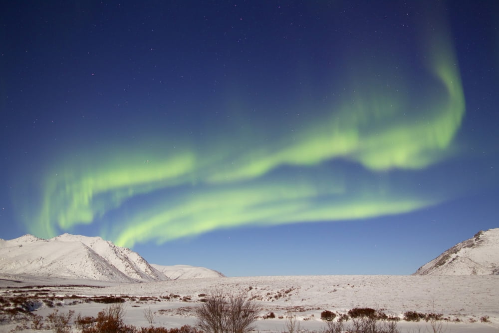 Aurora borealis with moonlight over Ogilvie Mountains Canada Canvas Art - Joseph BradleyStocktrek Images (18 x 12)