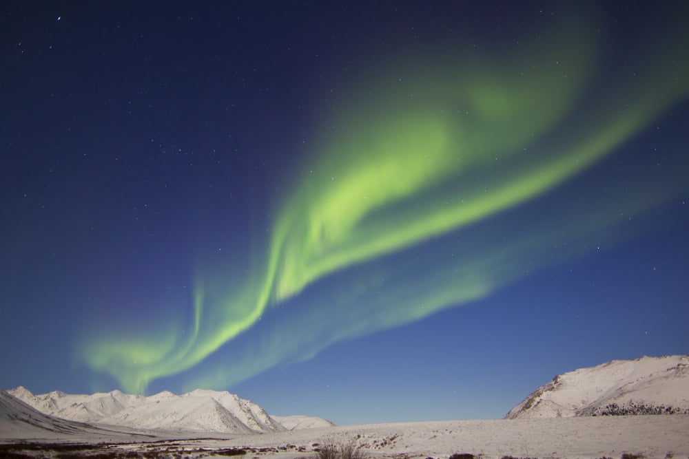 Aurora borealis with moonlight over Ogilvie Mountains Canada Canvas Art - Joseph BradleyStocktrek Images (18 x 12)