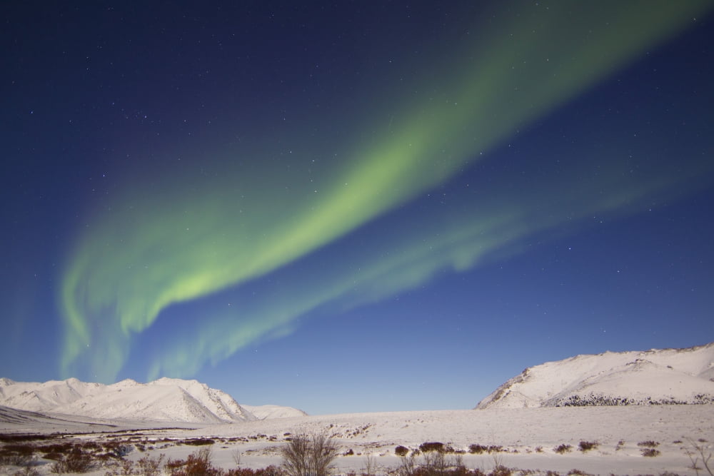 Aurora borealis with moonlight over Ogilvie Mountains Canada Canvas Art - Joseph BradleyStocktrek Images (35 x 23)