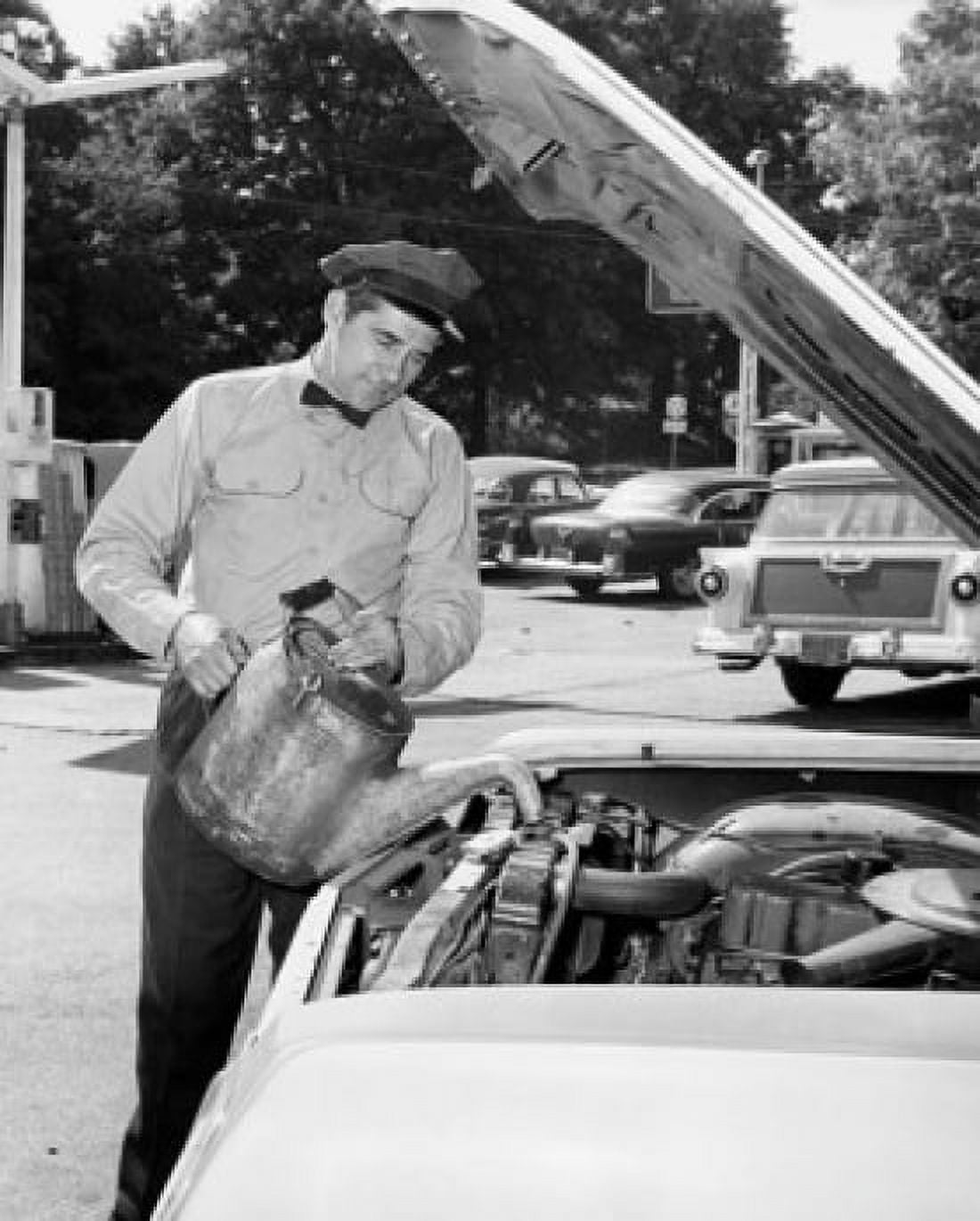 Auto mechanic pouring water in the radiator of a car Canvas Art - (18 x 24)