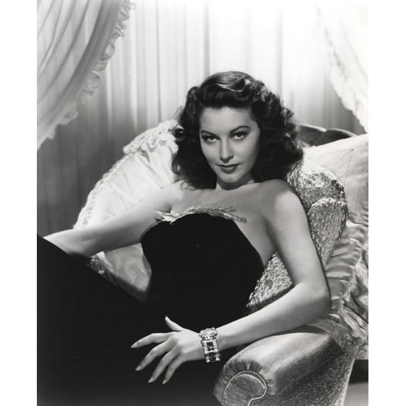 Ava Gardner Lying on a Couch wearing a Black Gown Photo Print (8 x 10)