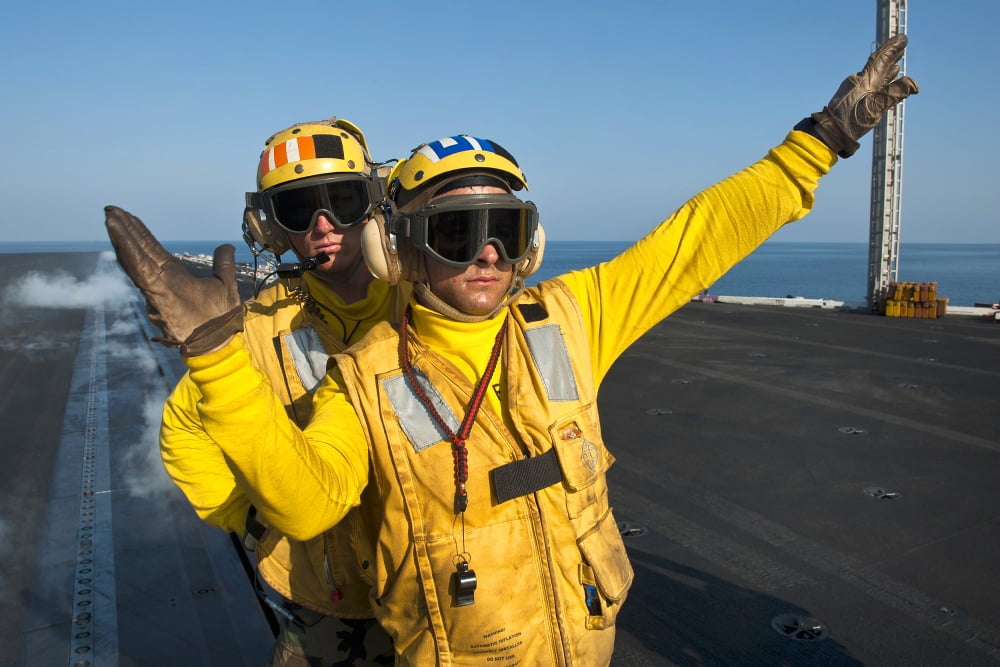Aviation Boatswain Mates direct an aircraft aboard USS John C Stennis Canvas Art - Stocktrek Images (35 x 23)