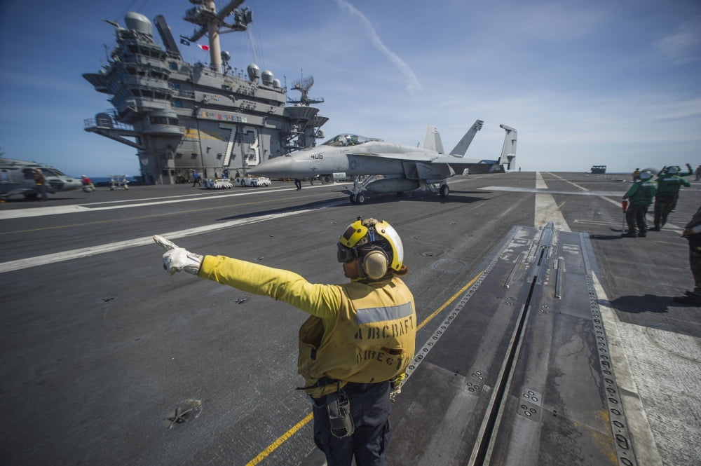 Aviation Boatswains Mate directs an FA-18E Super Hornet Canvas Art - Stocktrek Images (35 x 23)