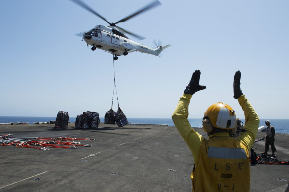 Aviation Boatswains Mate directs an SA-330J Puma helicopter Canvas Art - Stocktrek Images (35 x 23)