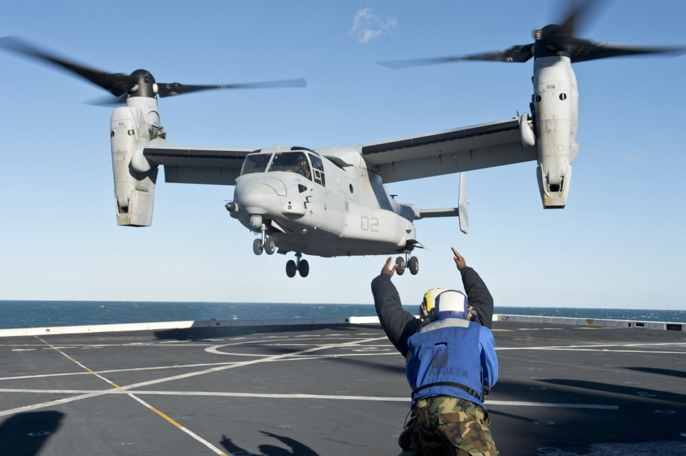 Aviation Boatswains Mate signals an MV-22 Osprey for liftoff Canvas Art - Stocktrek Images (35 x 23)