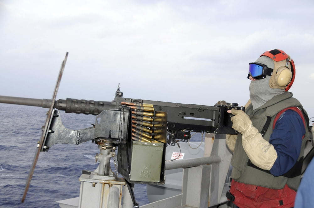 Aviation Ordnanceman fires a 50-caliber machine gun Canvas Art - Stocktrek Images (35 x 23)