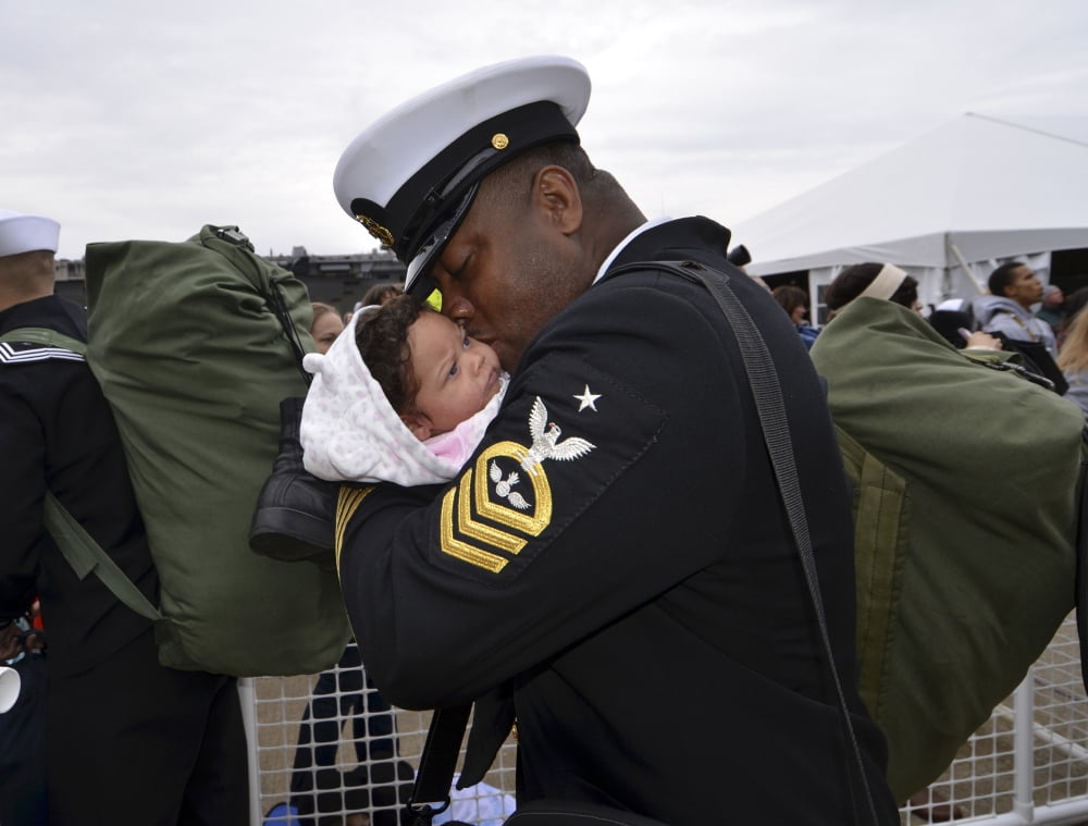 Aviation Ordnanceman kisses his newborn daughter during homecoming Canvas Art - Stocktrek Images (32 x 25)