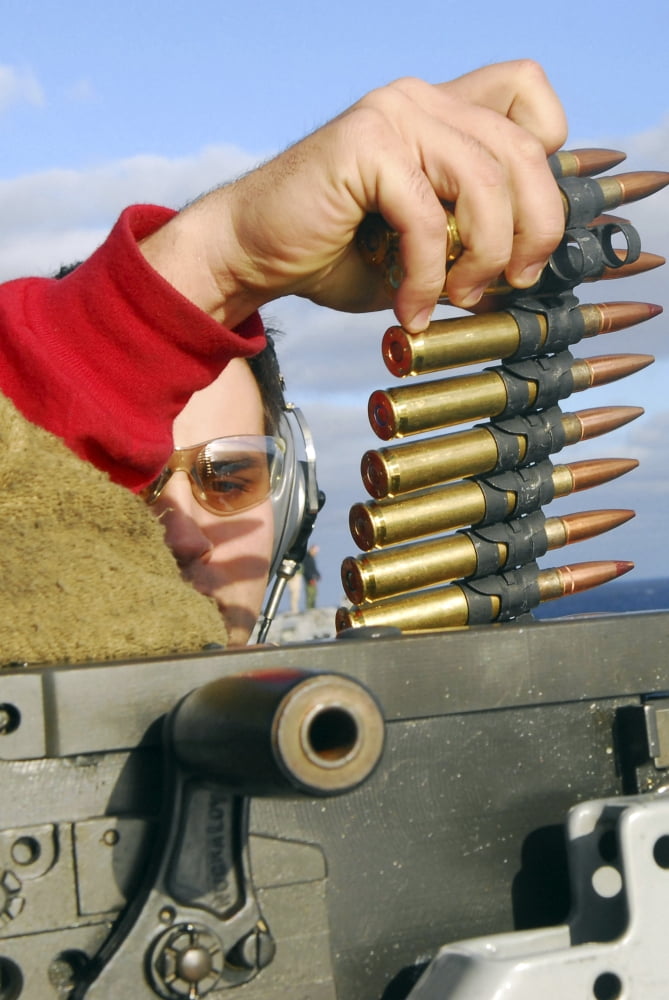 Aviation Ordnanceman reloads a 50-caliber machine gun Canvas Art - Stocktrek Images (23 x 34)