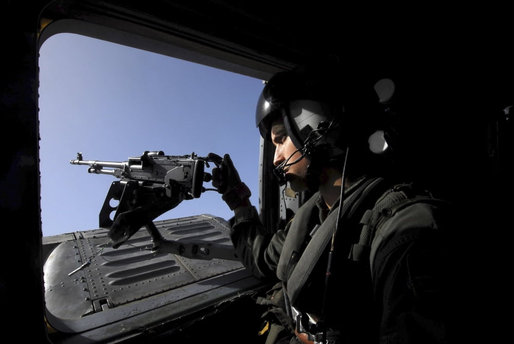 Aviation Warfare Systems Operator standing by a 50 caliber machine gun mount on an HH-60H Seahawk Canvas Art - Stocktrek Images (34 x 23)