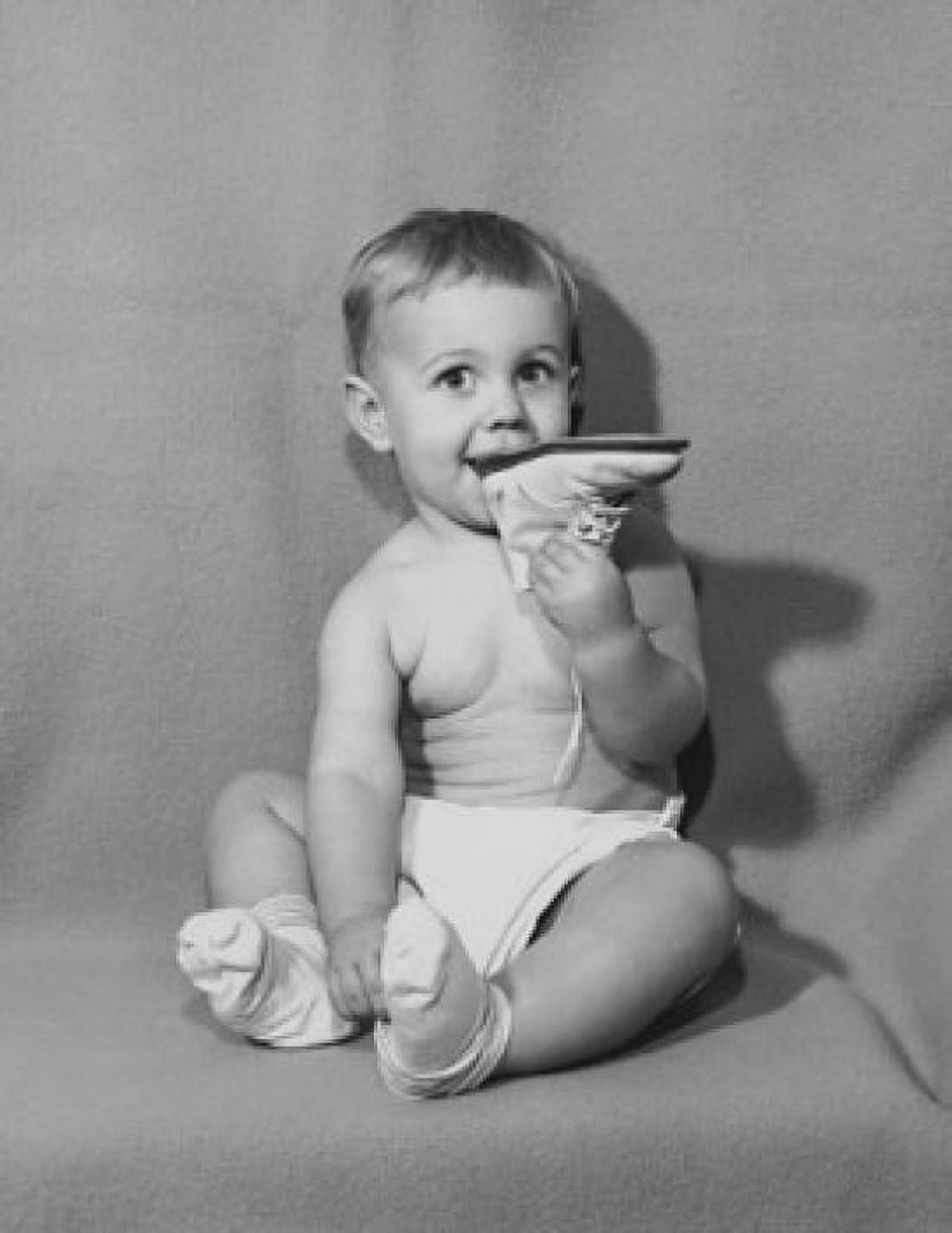 Baby biting a shoe Canvas Art - (24 x 36)