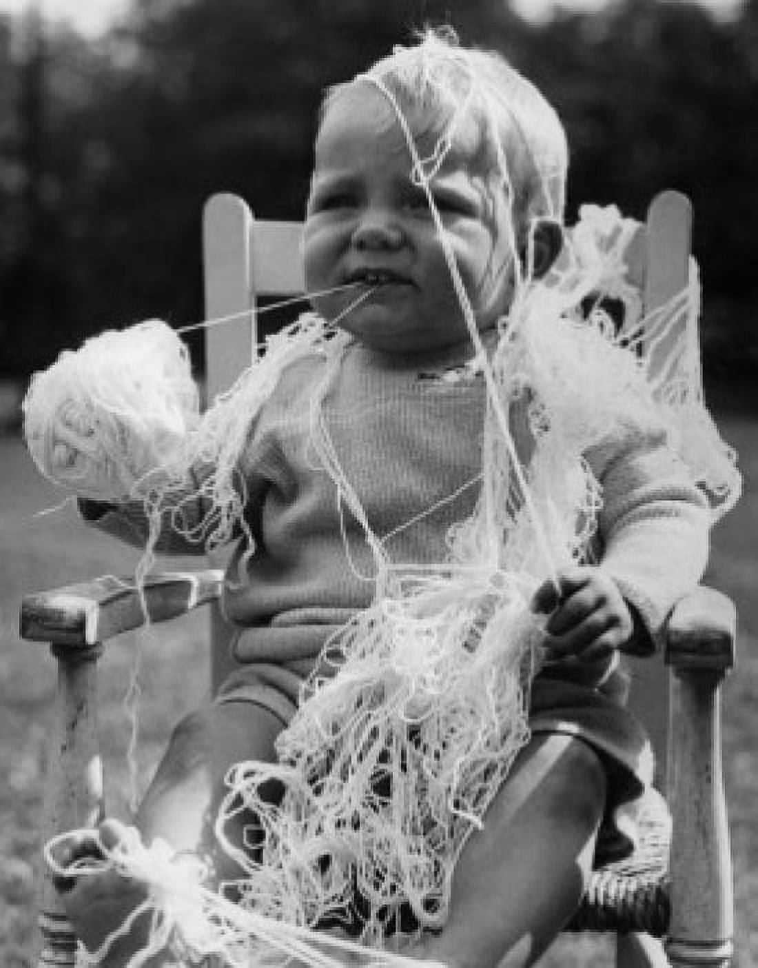 Baby boy covering by wool and holding ball of wool Canvas Art - (18 x 24)