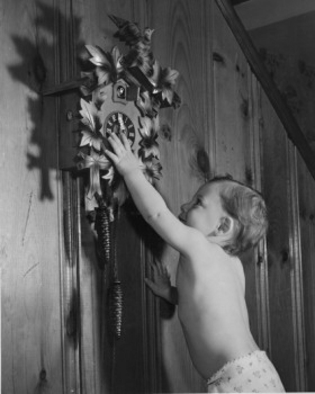 Baby boy reaching for cuckoo clock Canvas Art - (18 x 24)