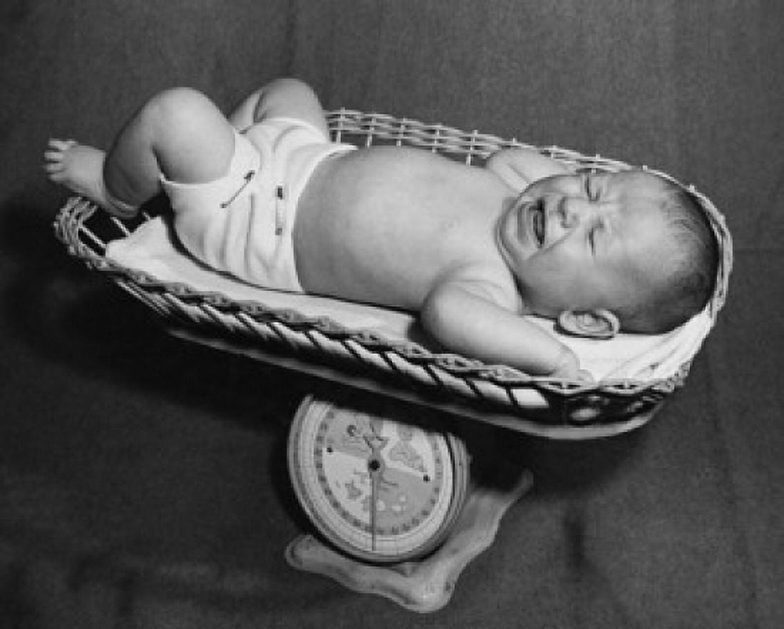 Baby crying in a weighing scales basket Canvas Art - (18 x 24)