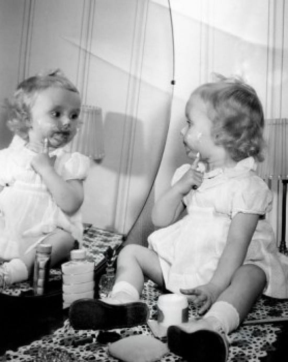 Baby girl applying cosmetics in front of mirror Canvas Art - (18 x 24)