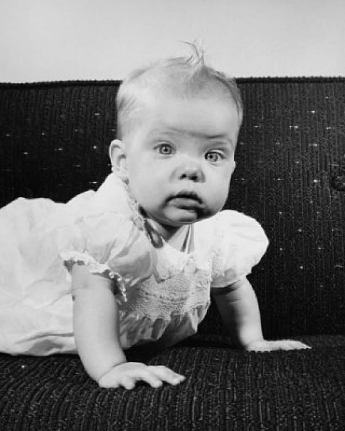 Baby girl crawling on a couch Canvas Art - (24 x 36)